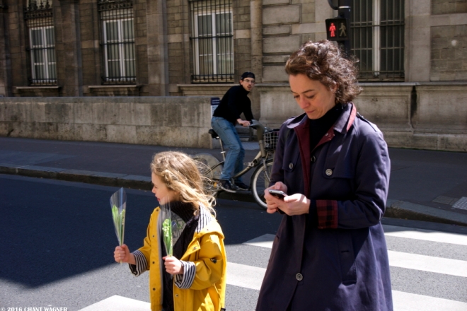 Little girl with lilies of the valley (muguet) in Paris on May Day.