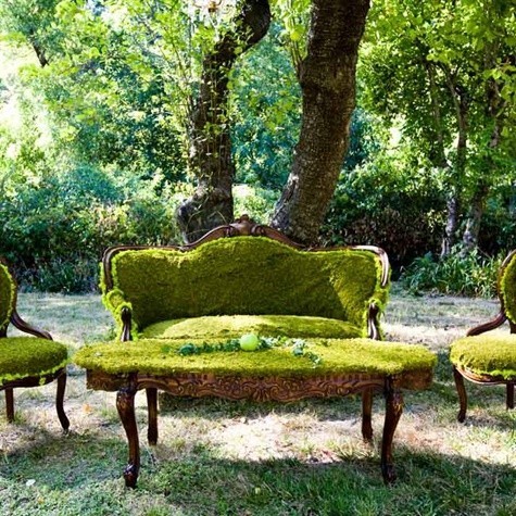 Set of green mossy furniture, chairs, sofa, table, outside.