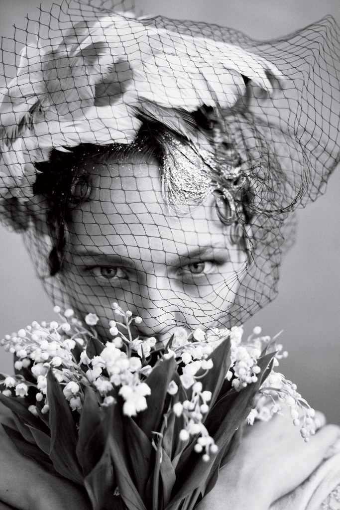 Fashion model Sasha Pivovarova with lilies of the valley; Vogue magazine.