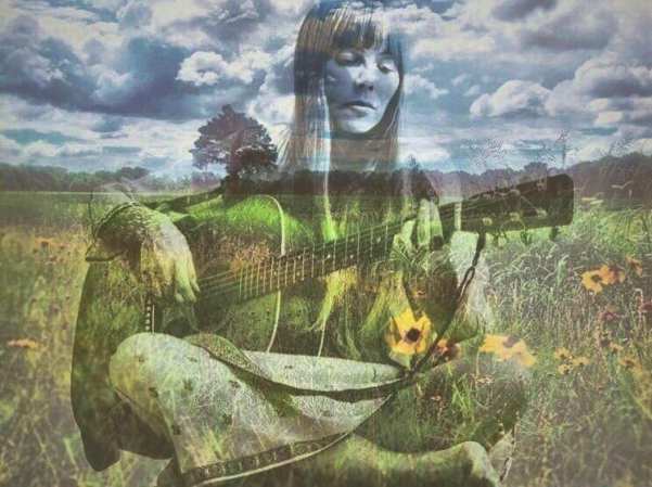 Singer songwriter Joni Mitchell with clouds, wildflowers and guitar